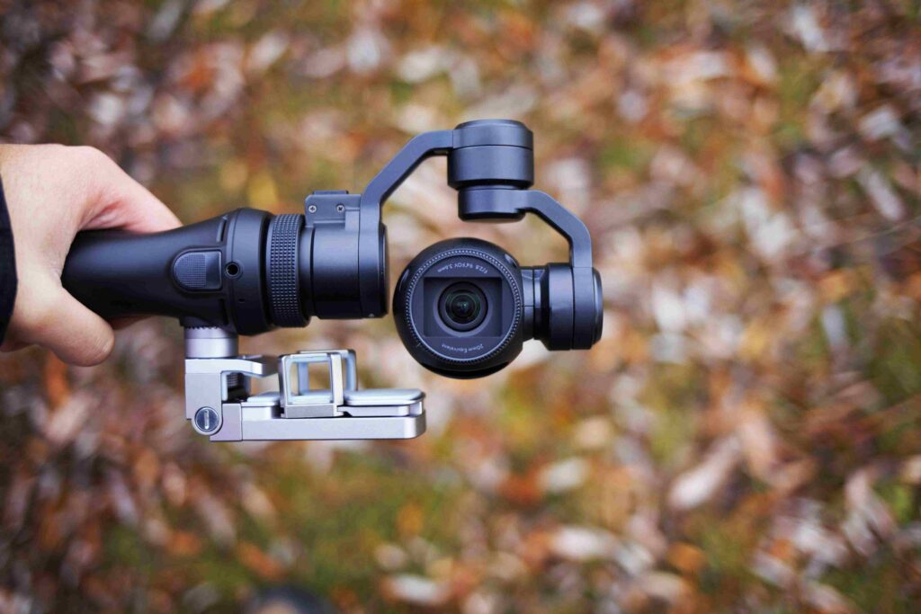 person holding black tripod with camera